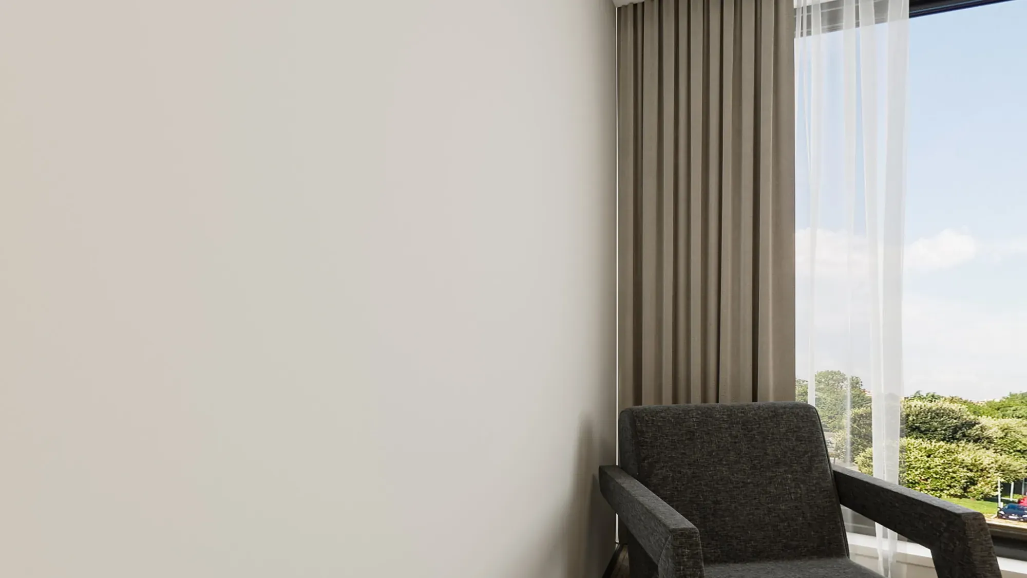 Master bedroom window lounge with charcoal upholstery