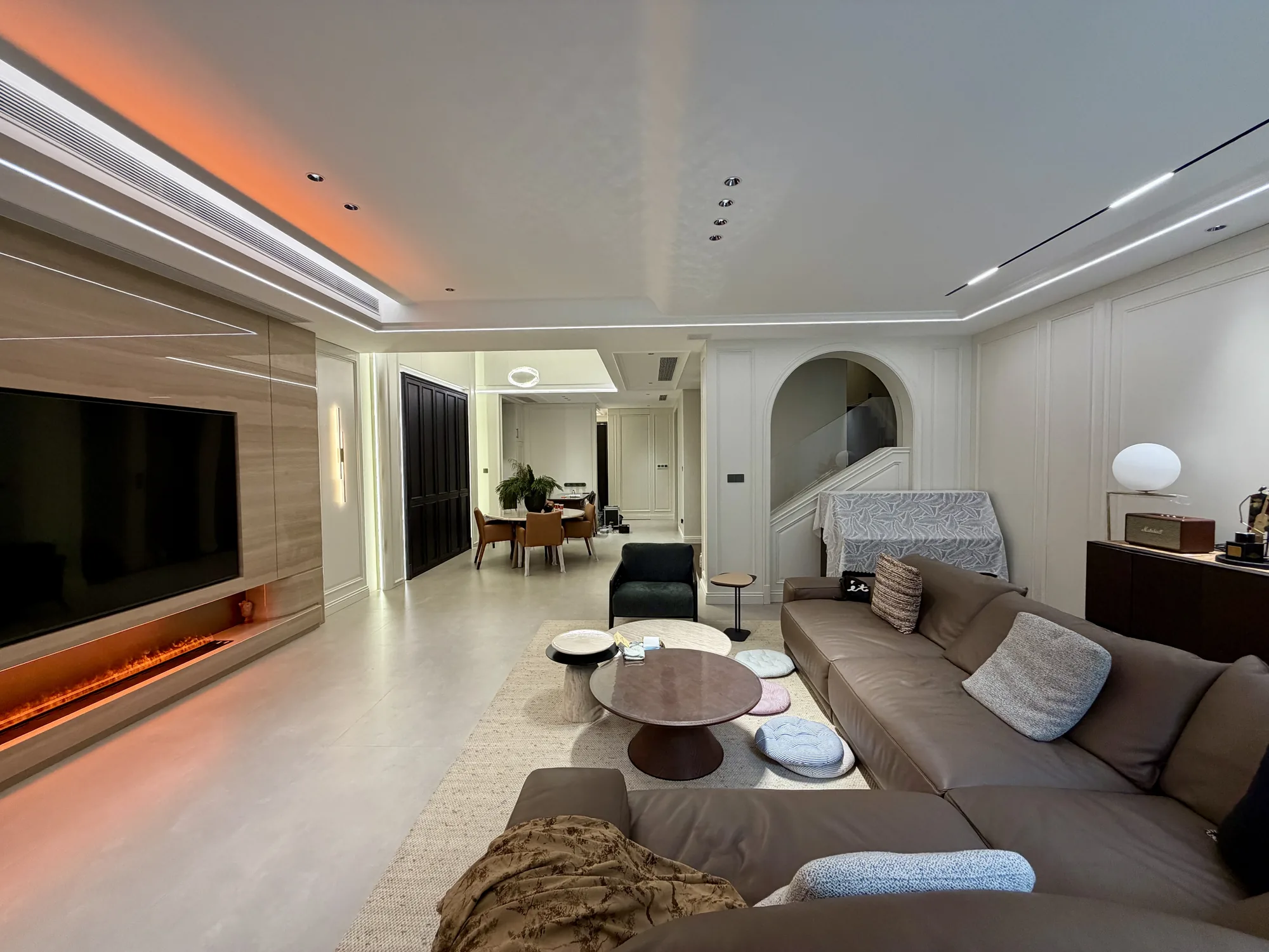 Cameroon warm modern classic villa living room with panelled walls and illuminated media wall
