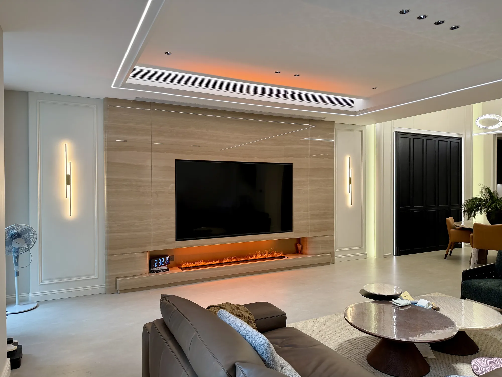 Light timber media wall with integrated linear fireplace and wall lights