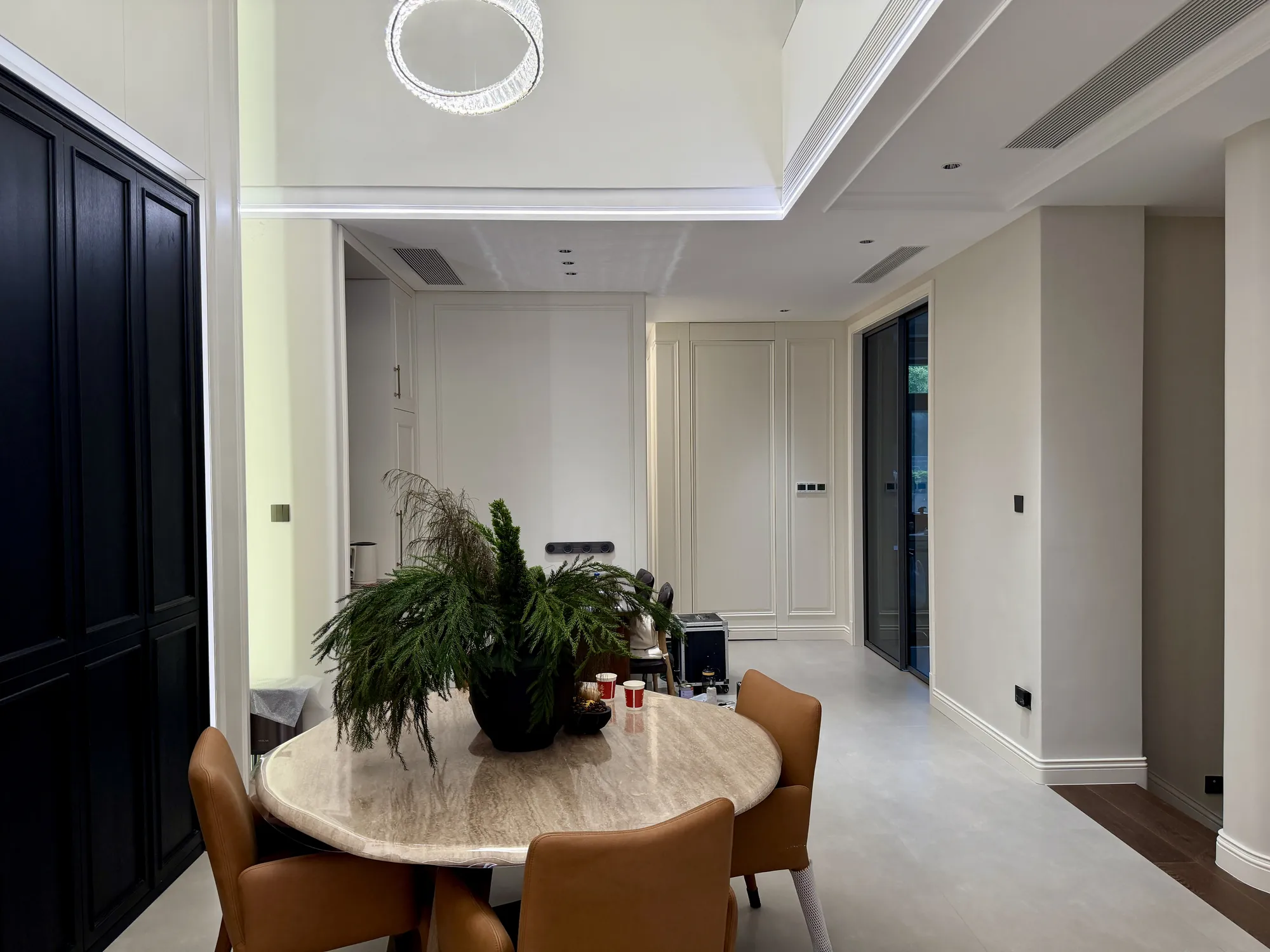 Villa circulation area with fitted wall panels and indoor planting