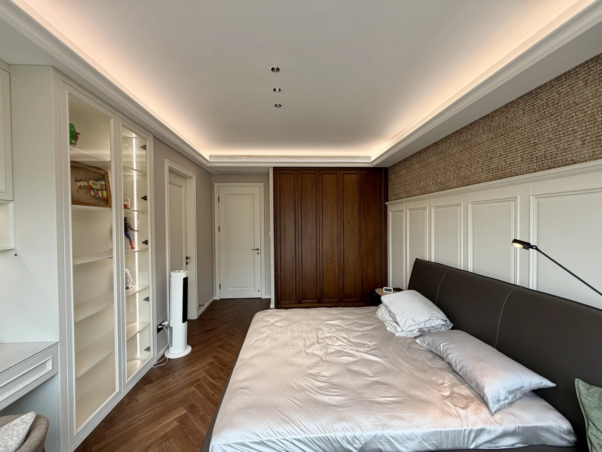 Bedroom with ivory panelled wardrobes, walnut door and built-in desk