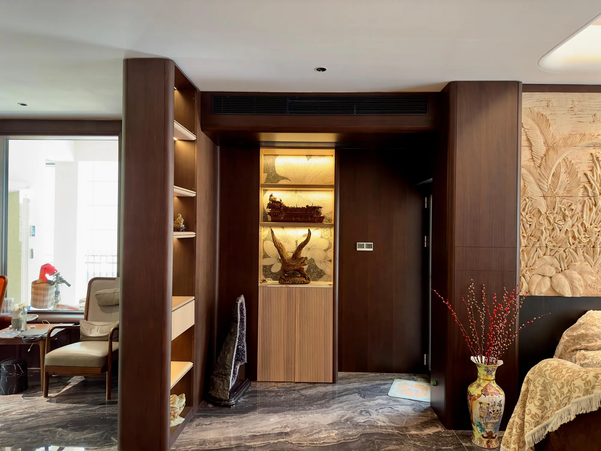 Illuminated timber portal connecting the villa circulation space and living room