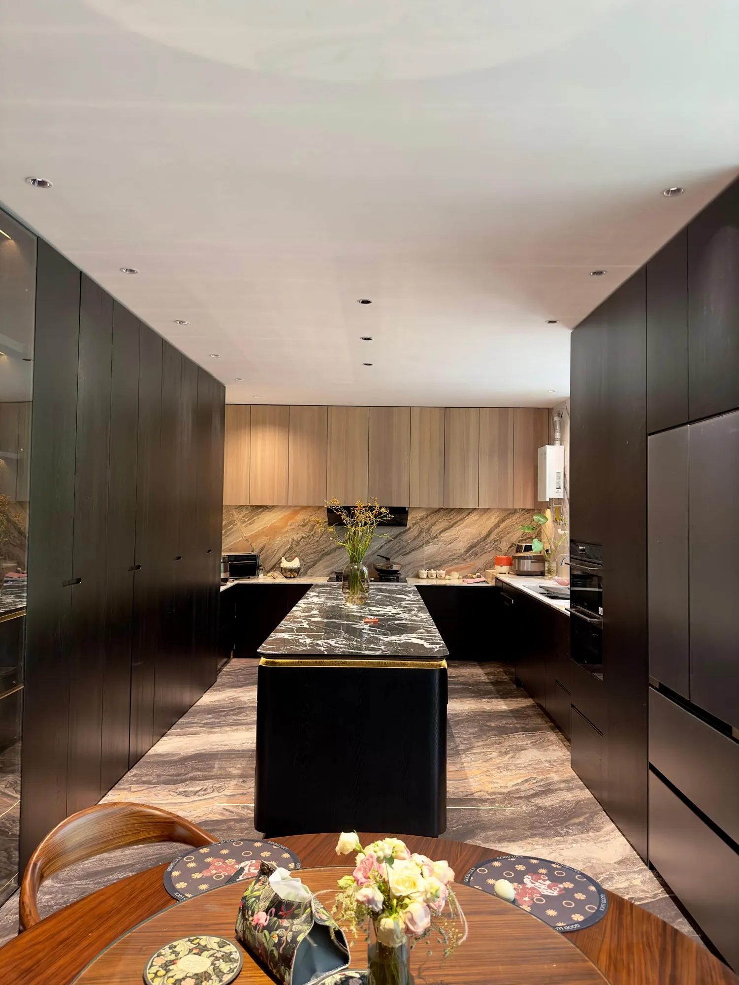Galley kitchen view showing integrated appliances and continuous fitted storage