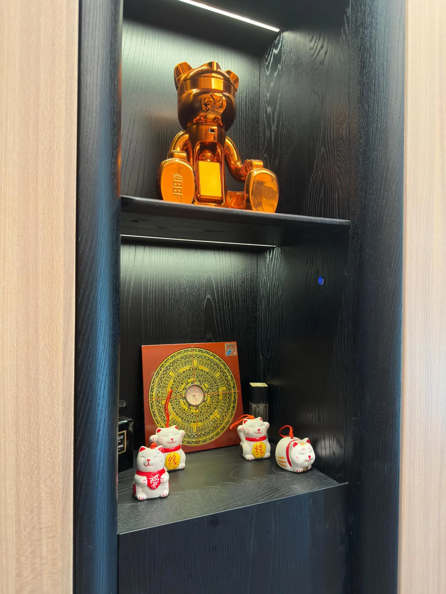 Black and oak display niche with concealed linear lighting