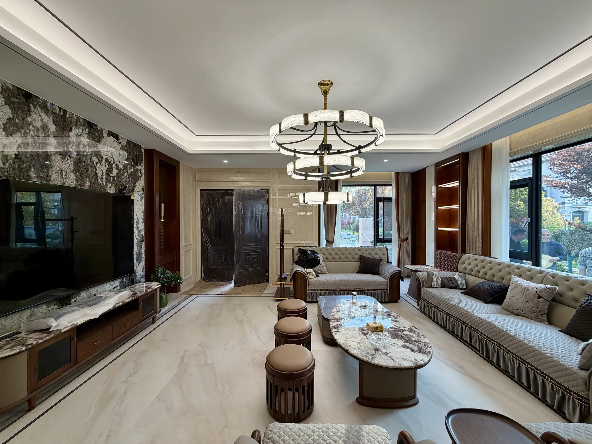 Symmetrical living room with marble media wall and walnut side panels