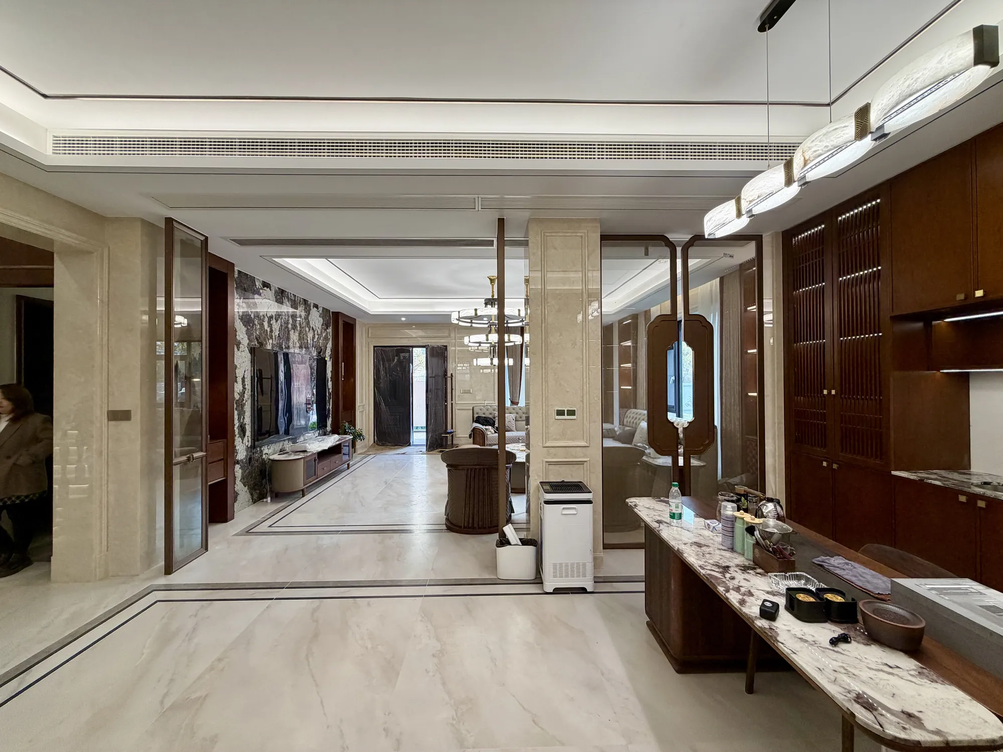 Long villa circulation view with fitted walnut wall panels