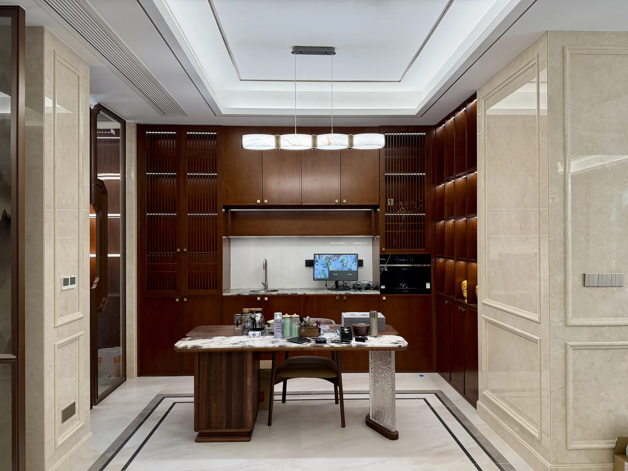Home study with full-height walnut shelving and integrated desk