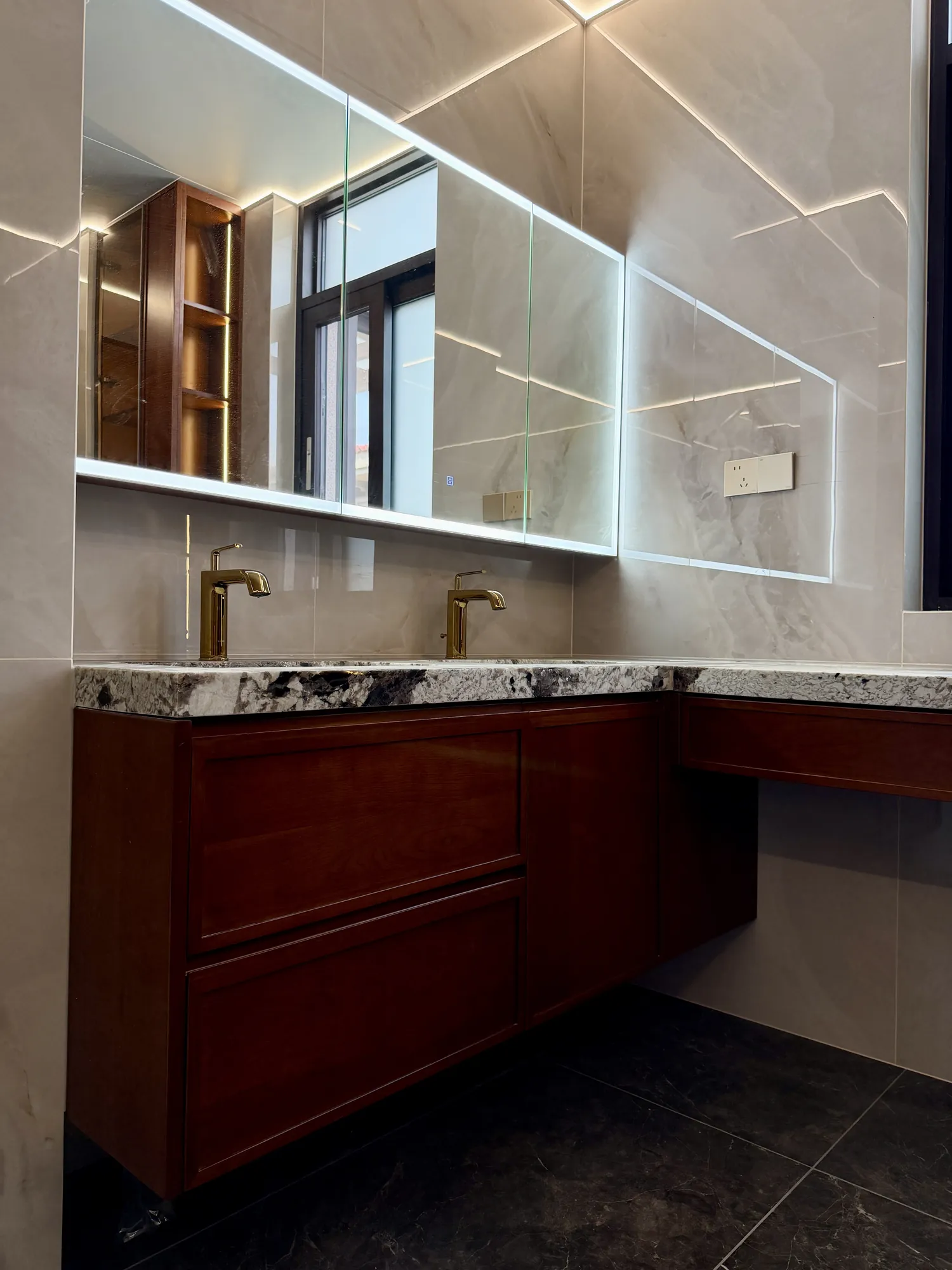 Walnut bathroom vanity with brass taps and mirrored storage