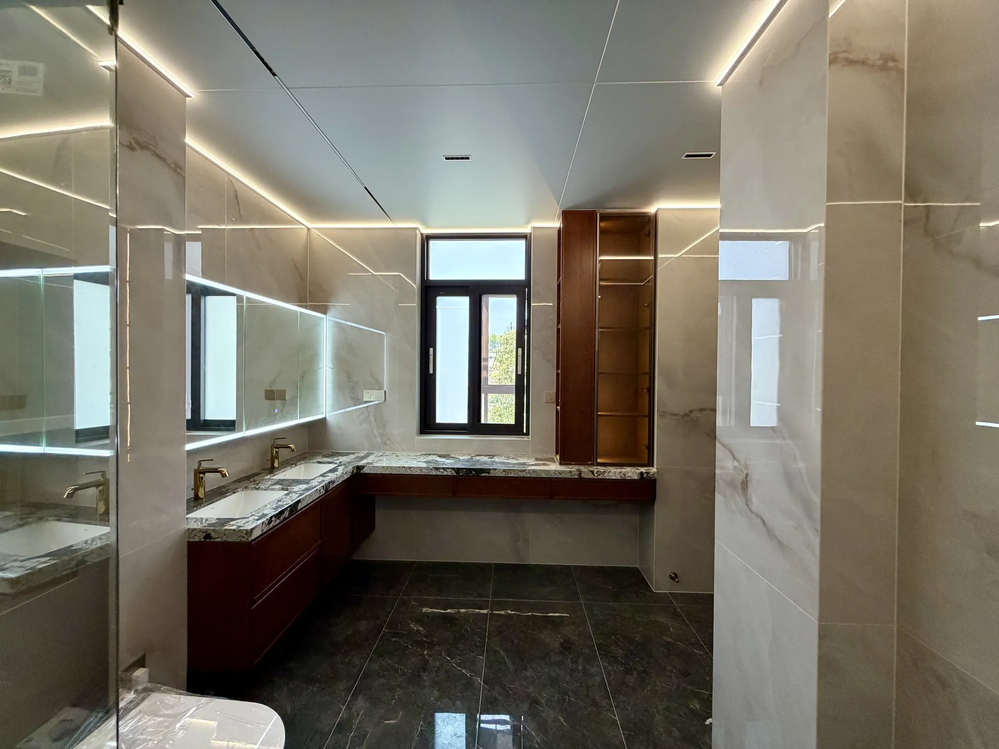 Walk-in wardrobe with illuminated timber shelves