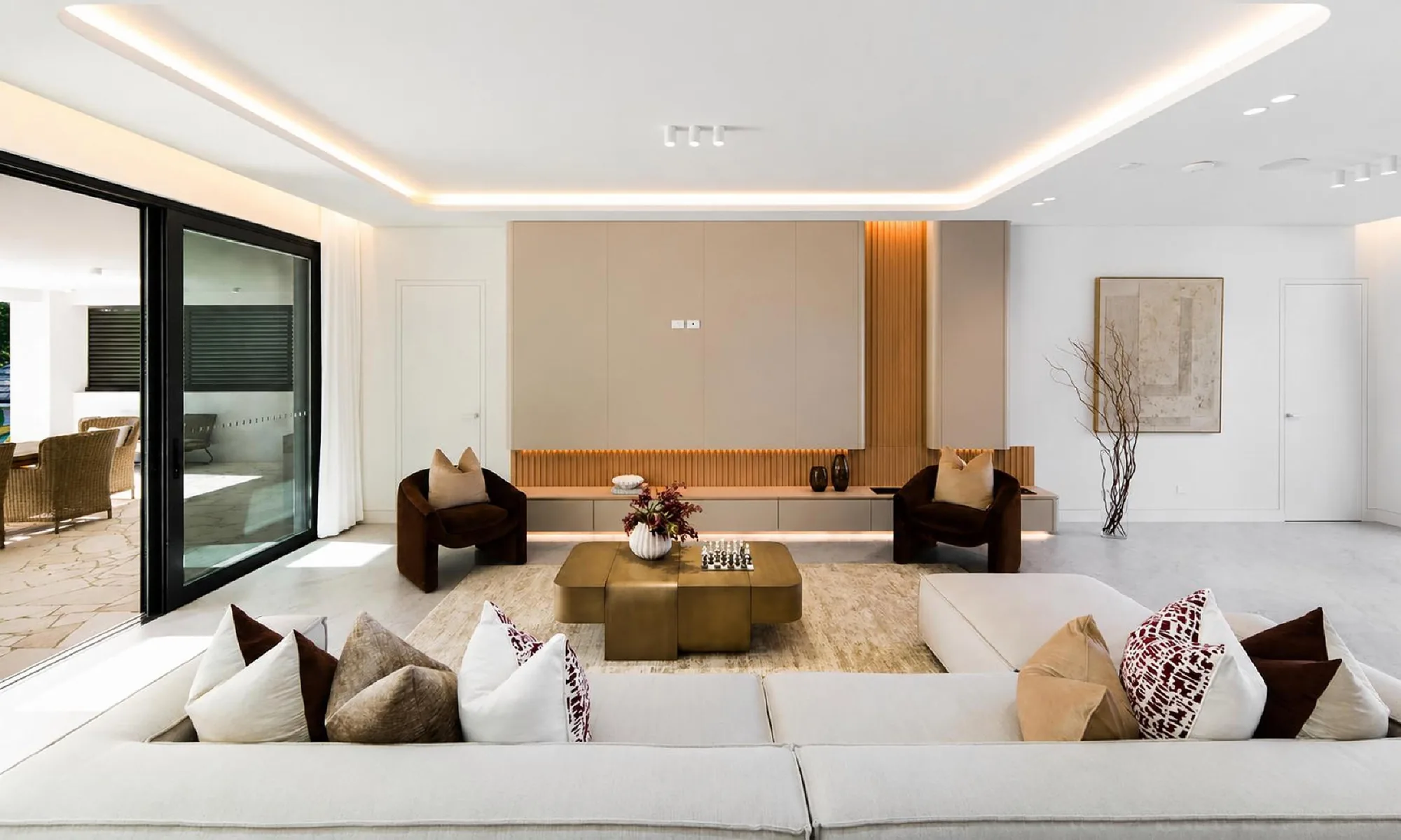 Mexico warm modern villa living room with pale fitted media wall and timber fluting