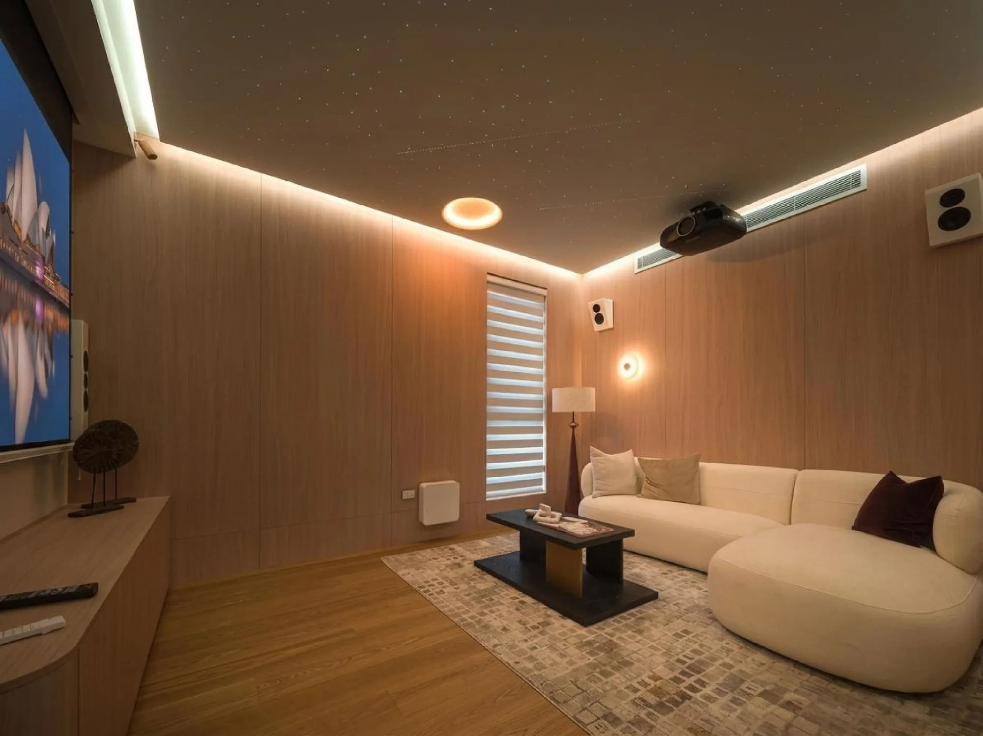 Warm timber media room with concealed lighting and integrated audiovisual equipment