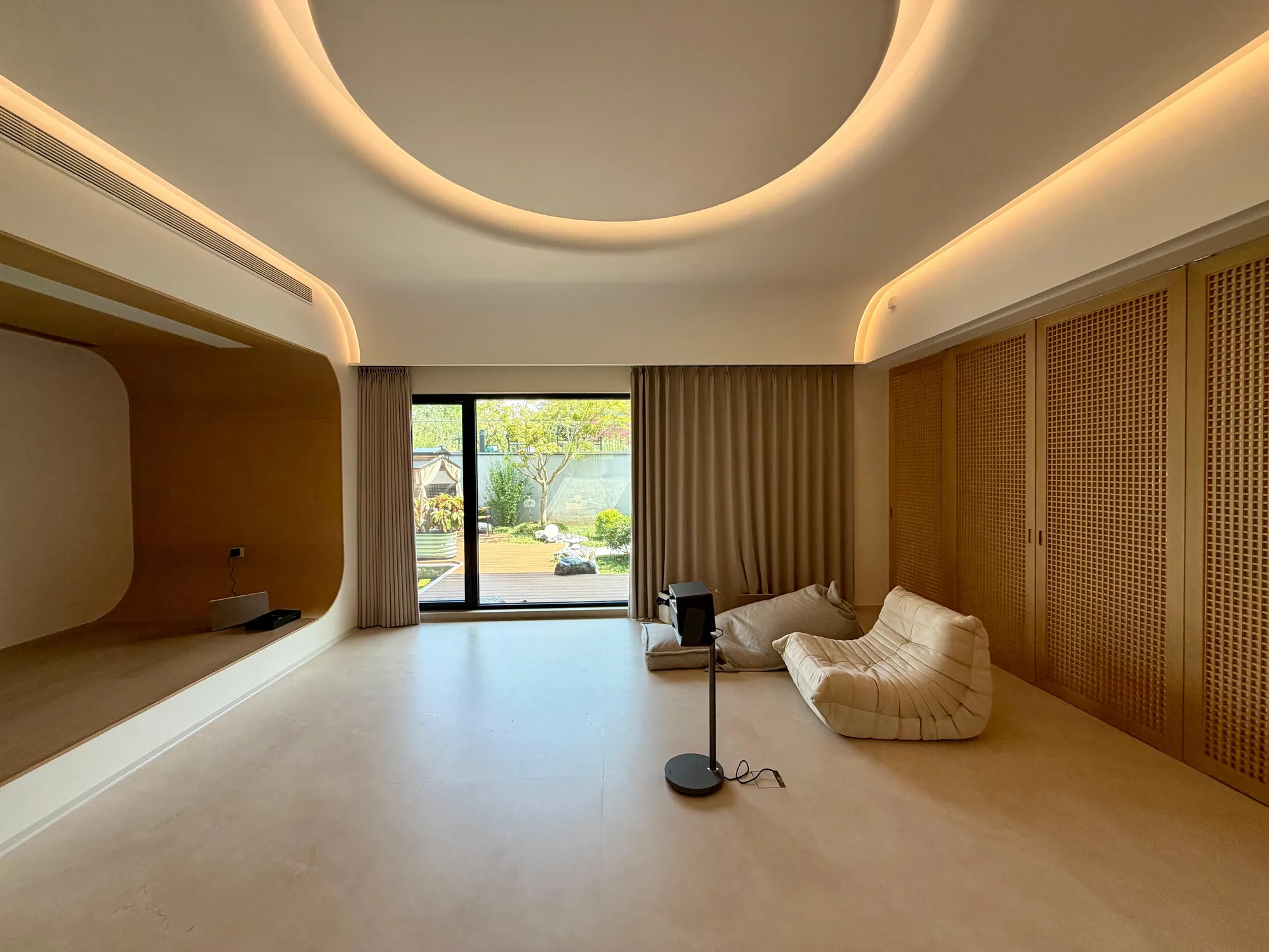 Family lounge with rattan-screen joinery and garden-facing light