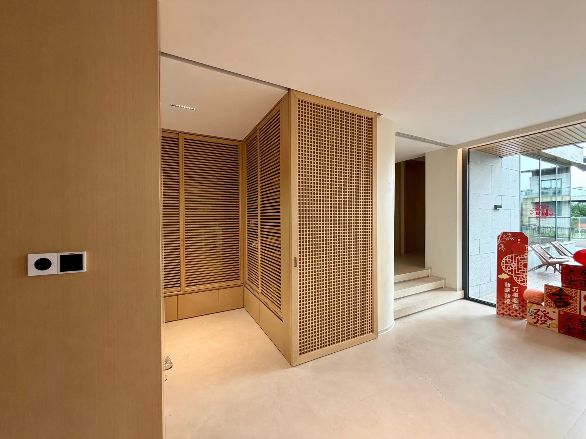 Entry foyer with hardwood lattice panels, rattan screens and pale flooring
