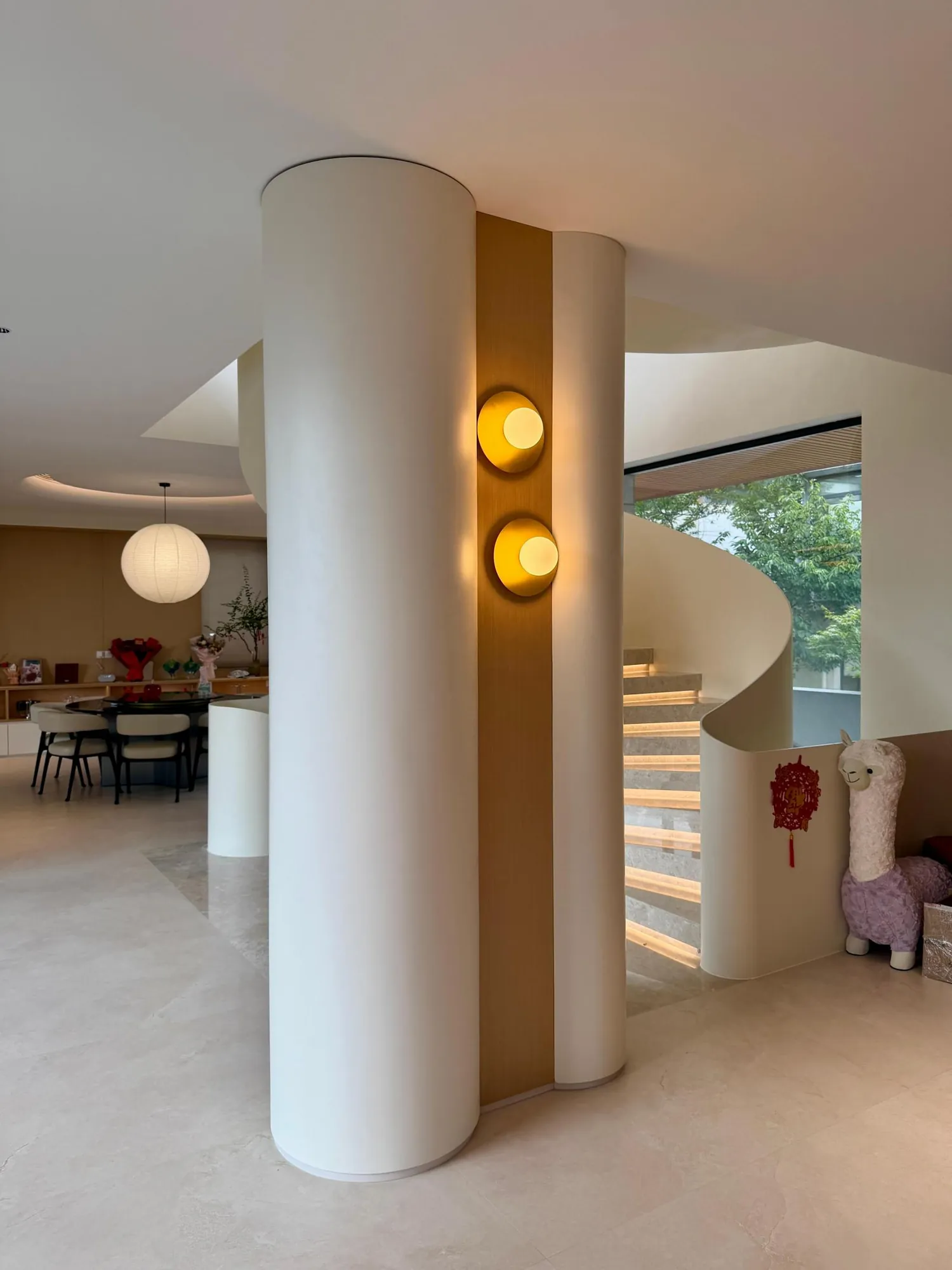 Sculptural entrance column with integrated warm wall lights