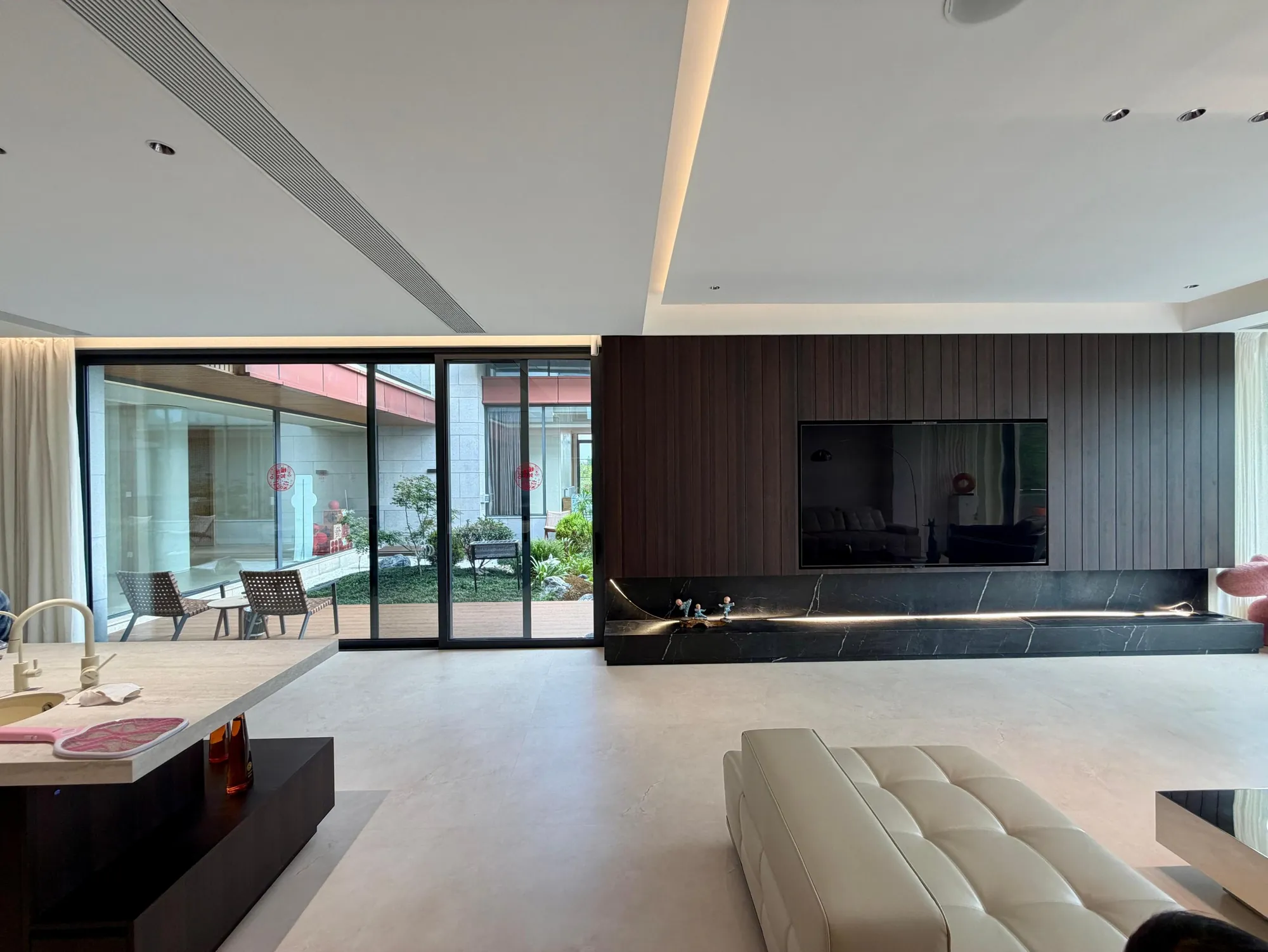 Dark timber media wall with low fitted storage in an open living room