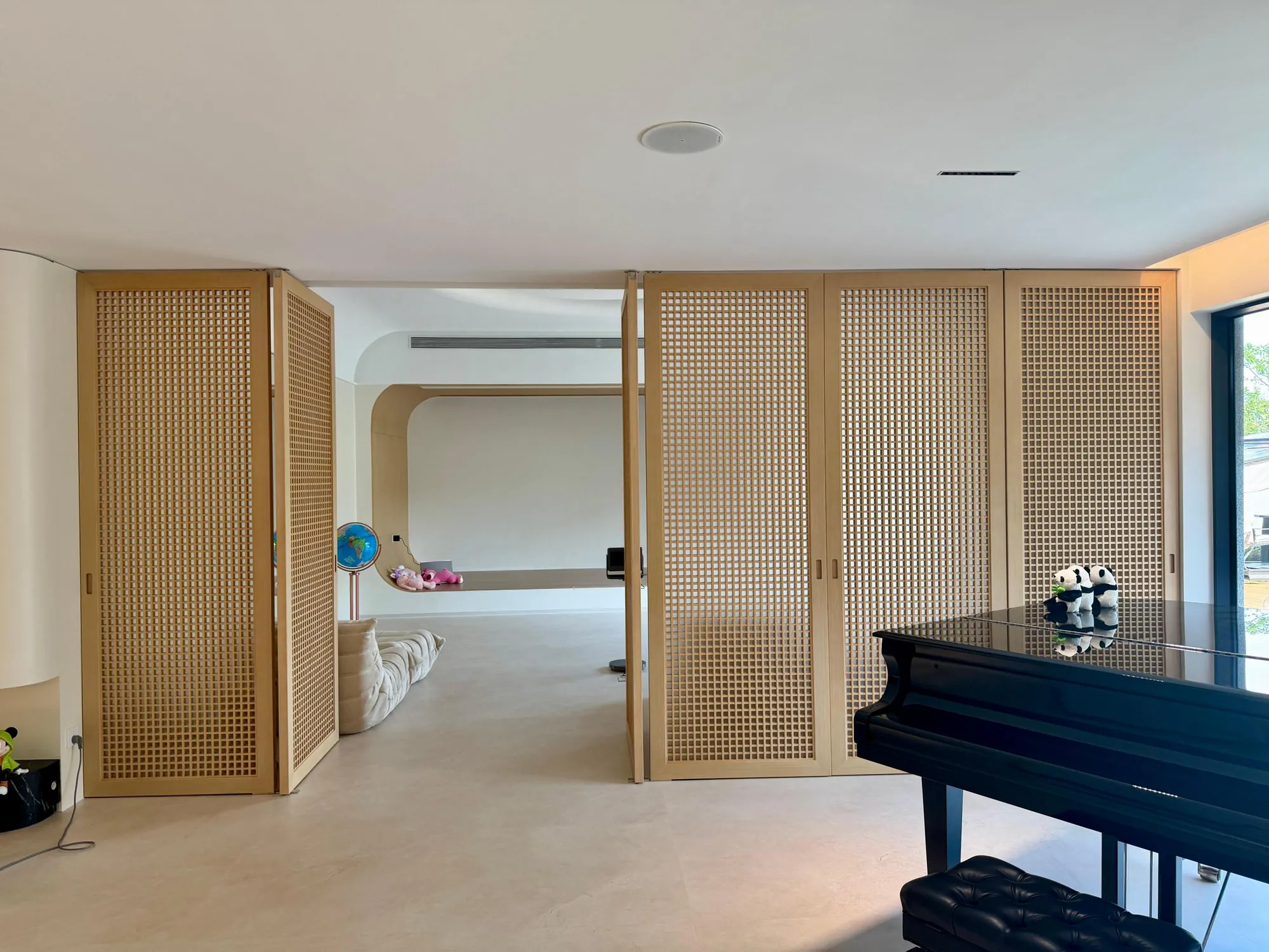 Pivot timber screens connecting the living room and adjacent space