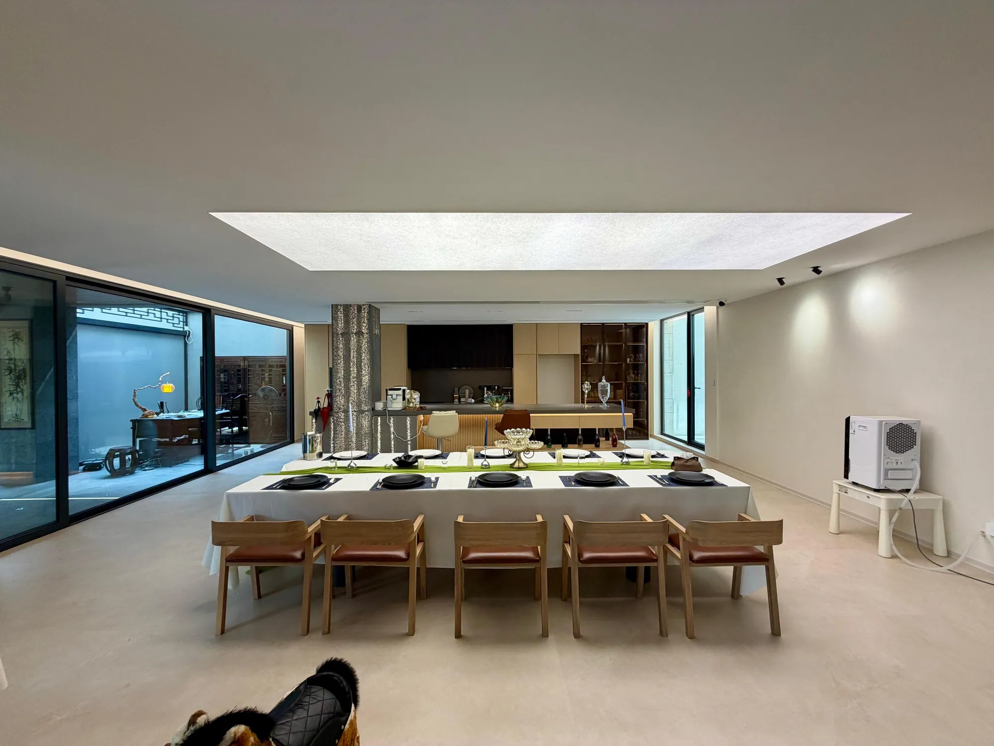 Wide kitchen with dark island and warm integrated lighting