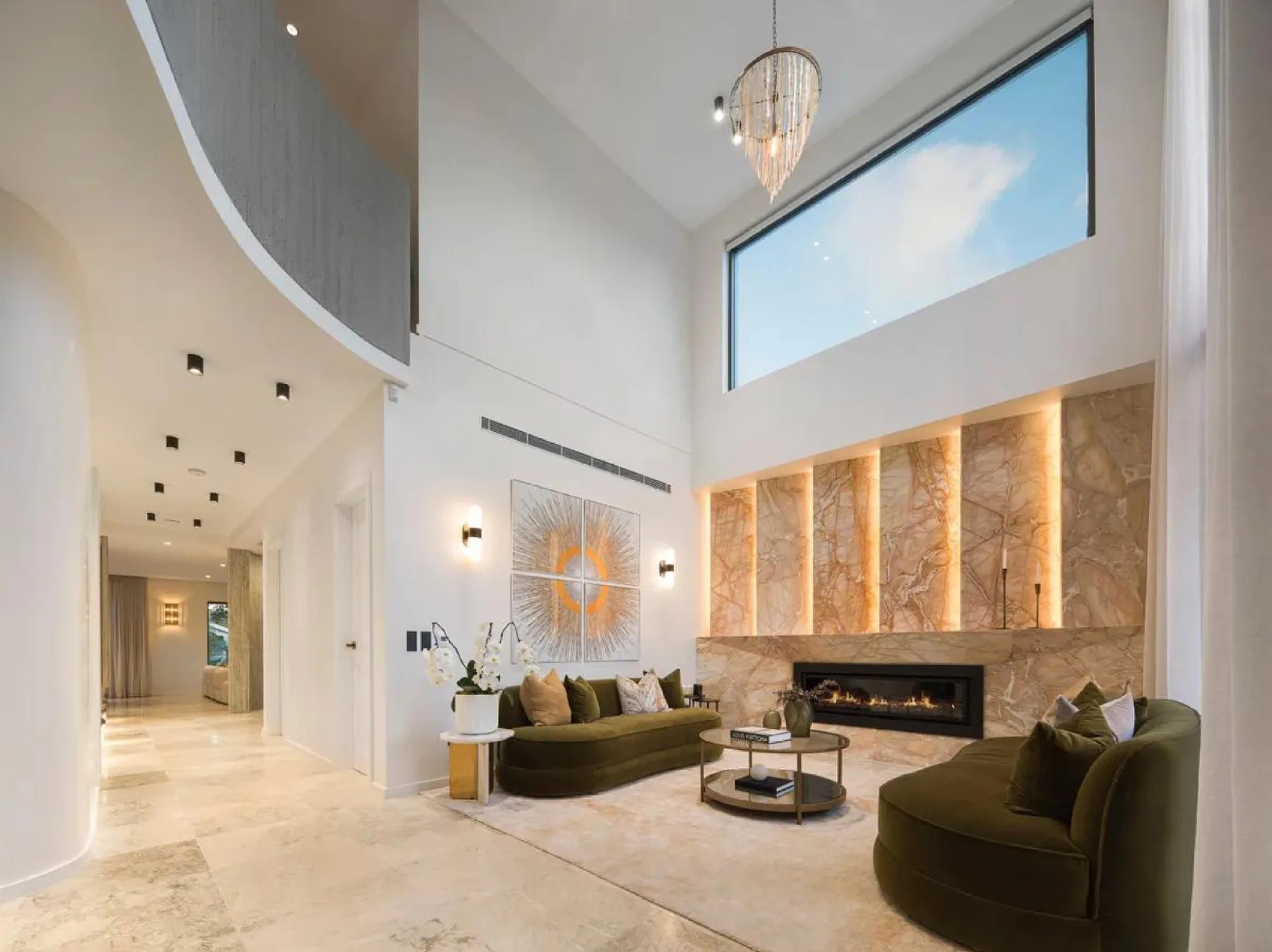 Spain warm contemporary villa living room with double-height glazing and timber feature wall