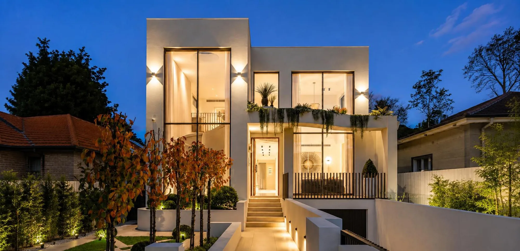 Contemporary two-storey villa exterior shown at dusk