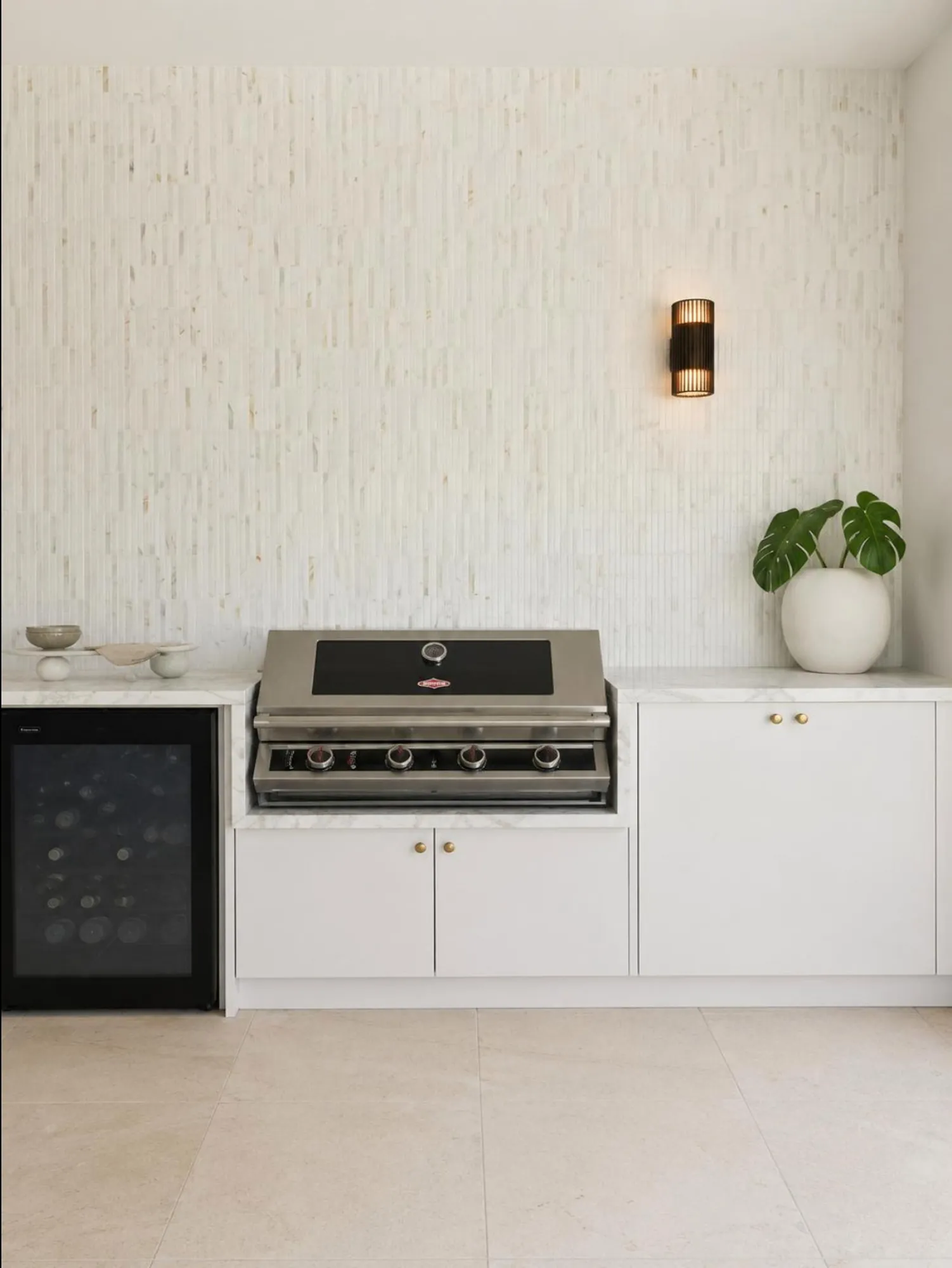 Covered outdoor kitchen with fitted storage and barbecue