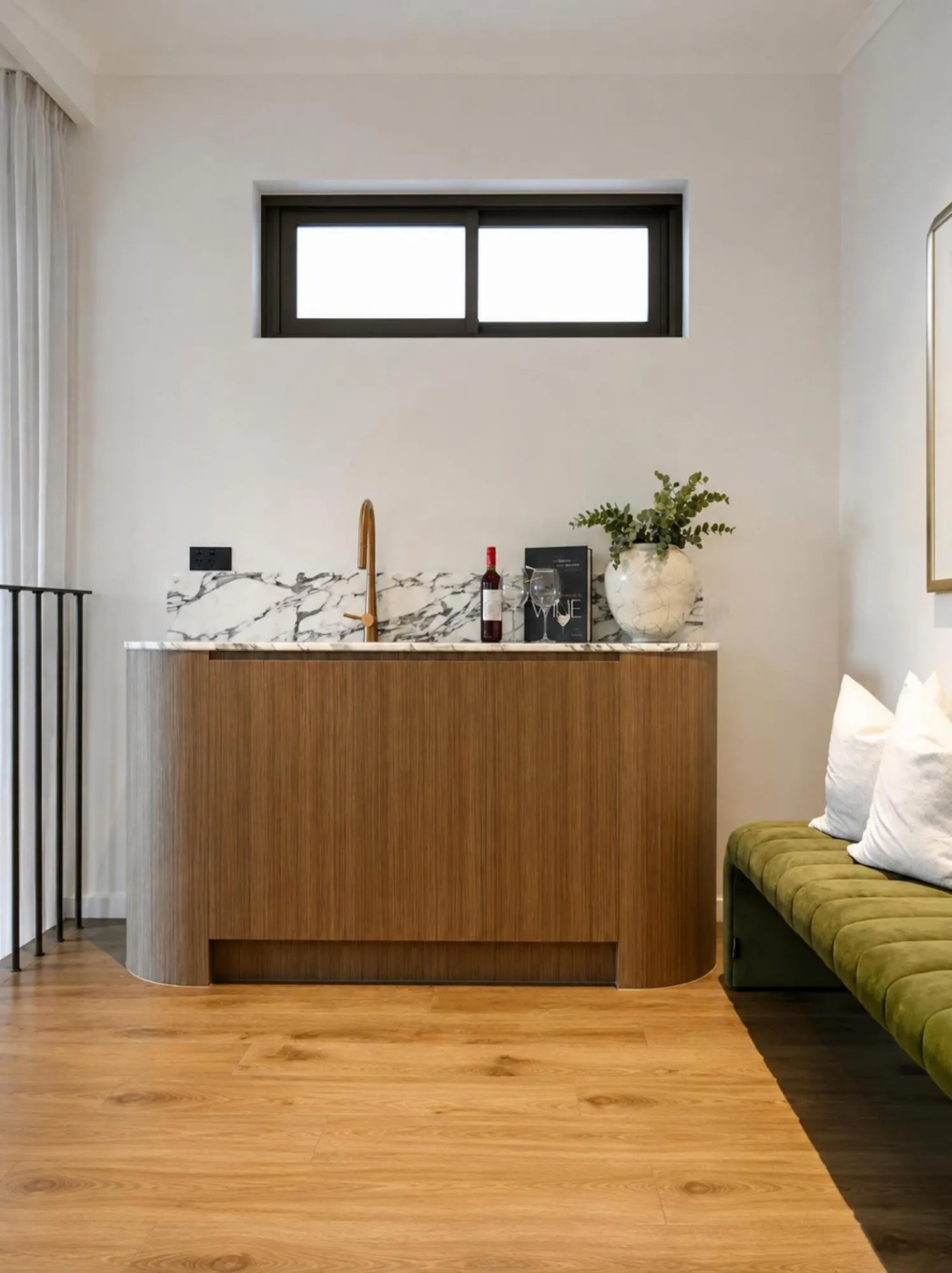 Family room with compact warm timber storage and clean white walls