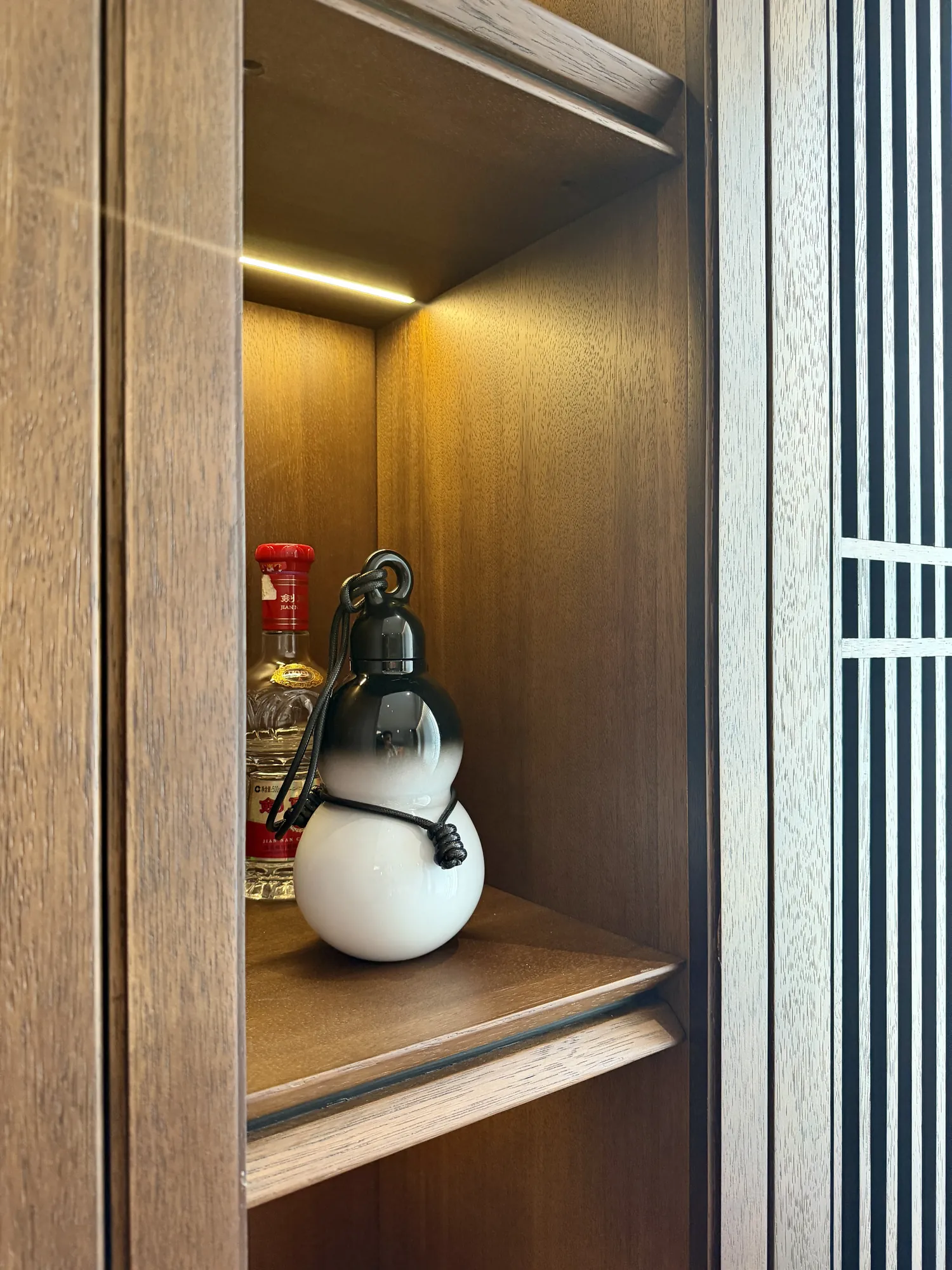 Main bedroom with dark walnut grille headboard wall and concealed lighting