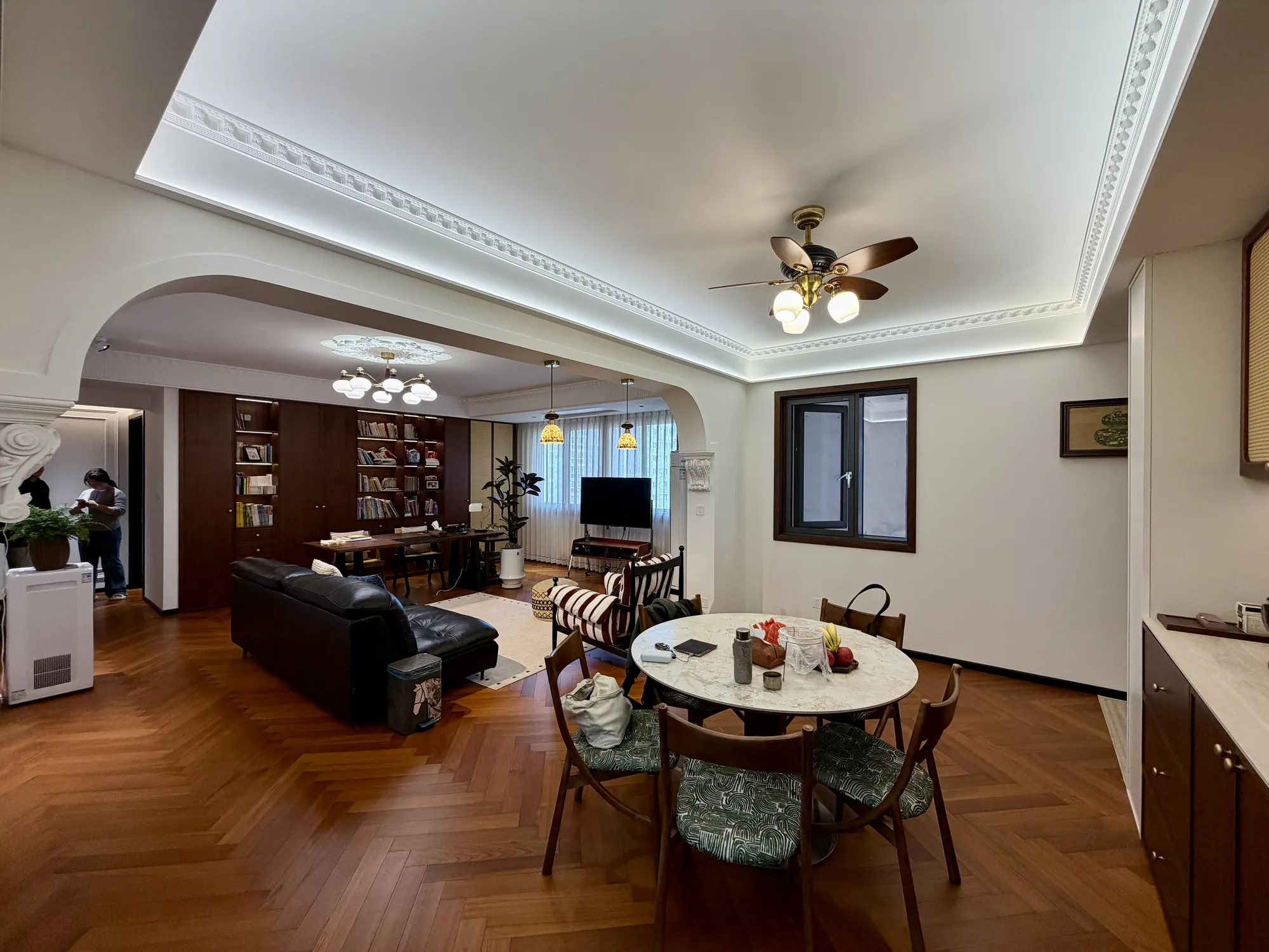 Arched dining room with chandelier and coordinated black-walnut custom millwork