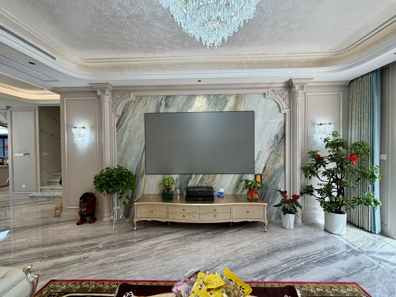 French-vintage living room with marble media wall and painted hardwood frames