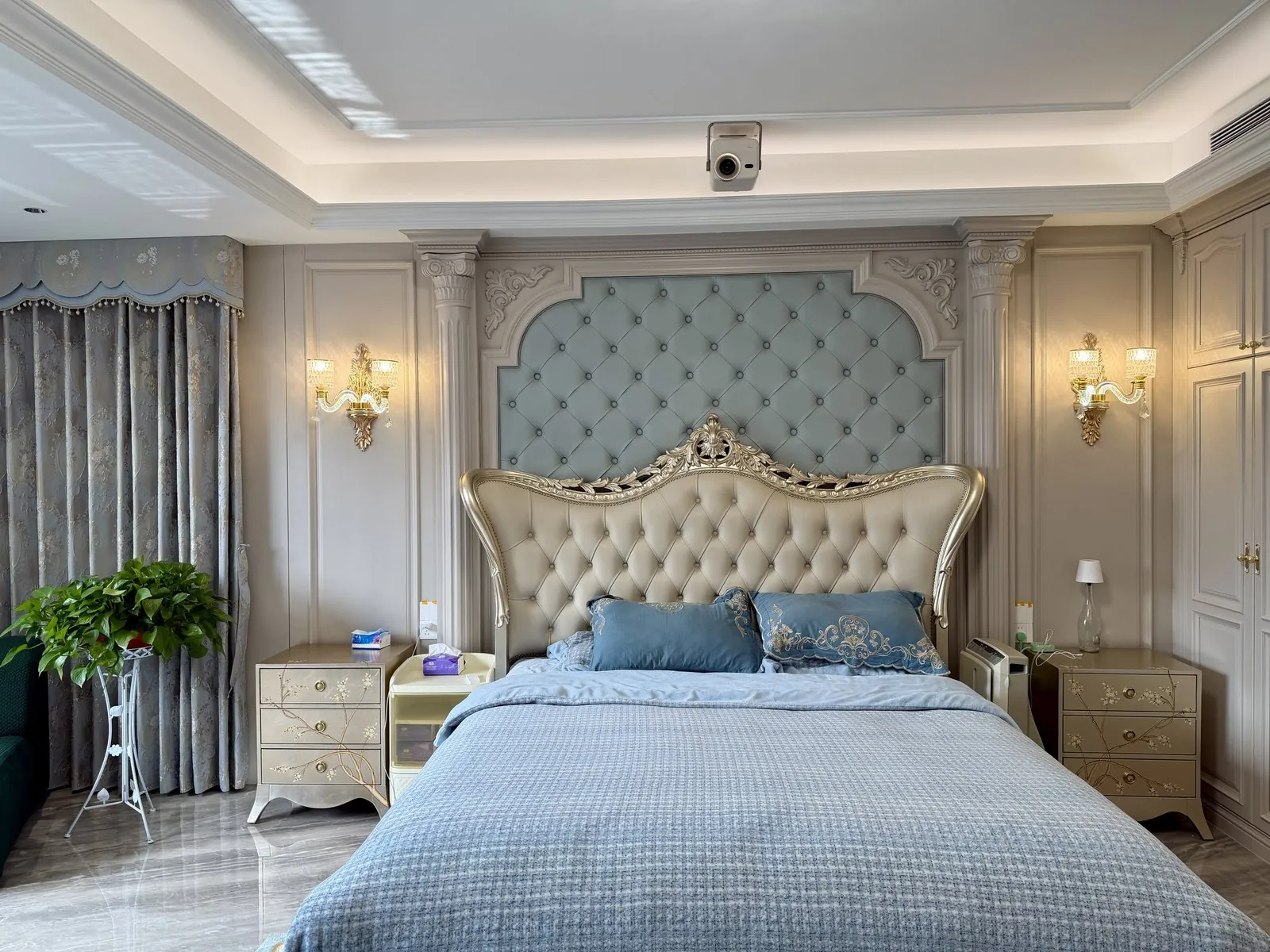 Detail of upholstered headboard within a moulded hardwood surround