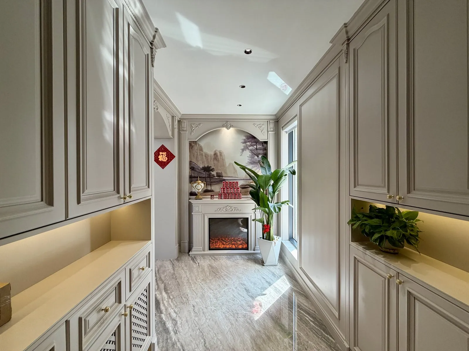 Marble floor and fitted cabinetry in the entrance foyer