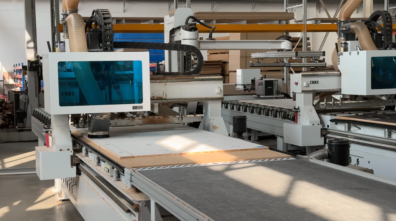 CNC machining equipment processing cabinet panels at GREENWAY
