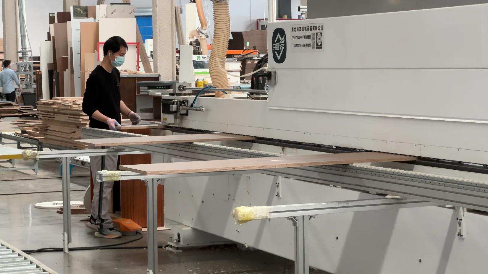 Operator processing cabinet panels at GREENWAY