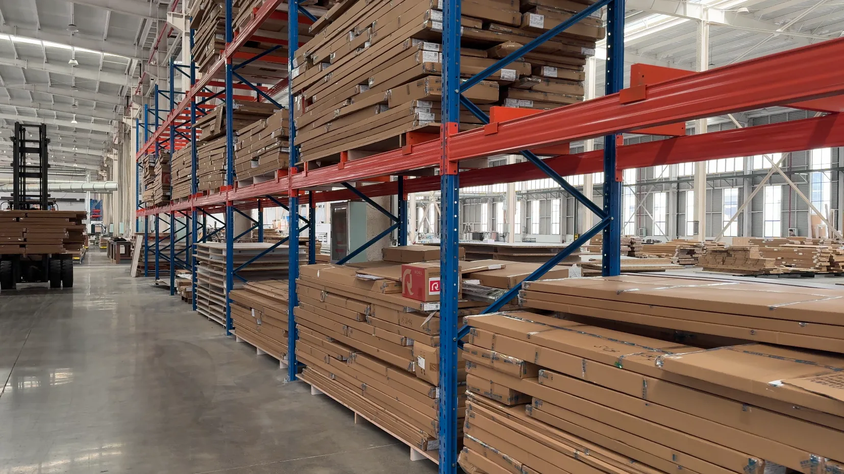 Warehouse racks holding packaged cabinet components at GREENWAY