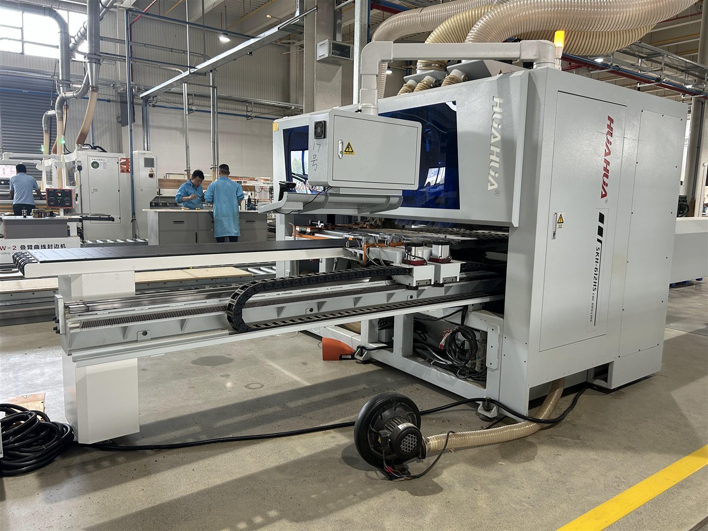 Actual cabinet production equipment and staff inside the Greenway production base